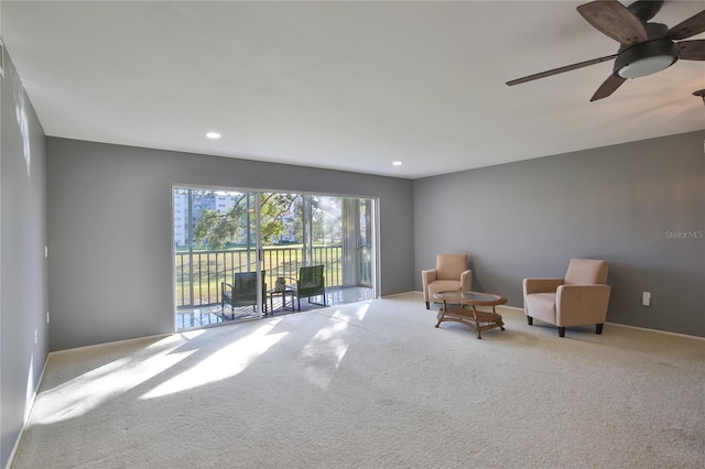 unfurnished room with ceiling fan and light carpet