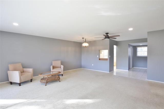 unfurnished room featuring ceiling fan and light carpet