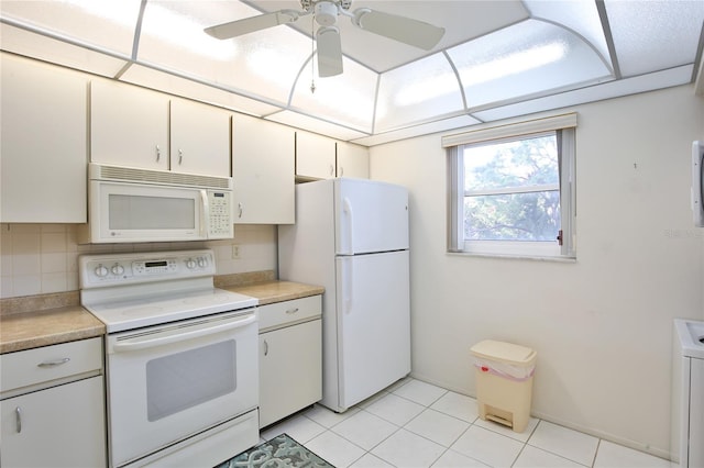 kitchen featuring tasteful backsplash, white appliances, ceiling fan, light tile patterned floors, and white cabinetry