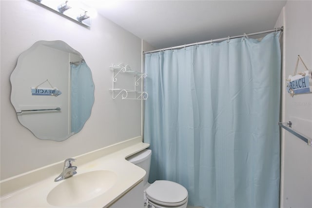 bathroom with walk in shower, vanity, and toilet