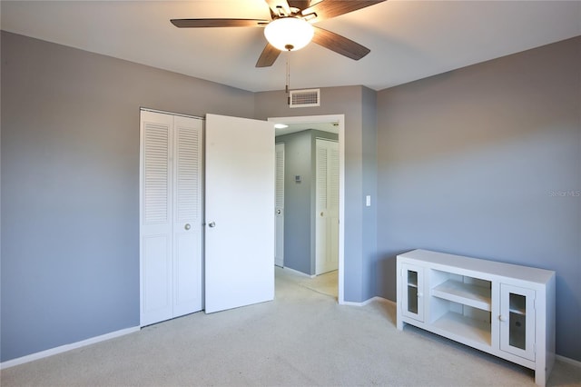 carpeted bedroom with a closet and ceiling fan