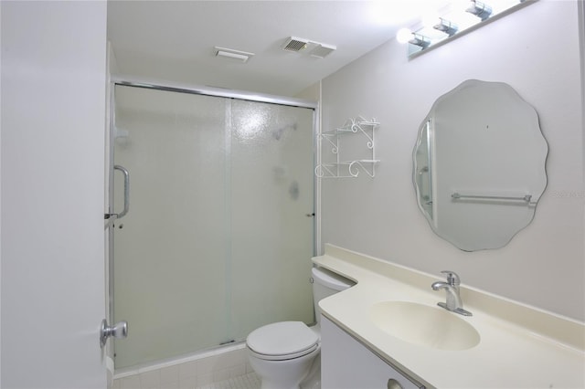 bathroom with tile patterned floors, toilet, an enclosed shower, and vanity