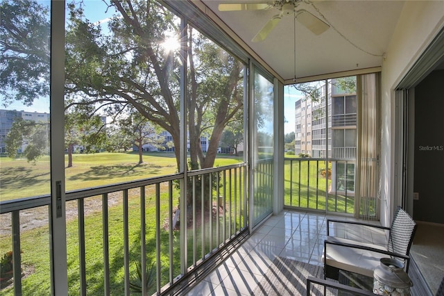 unfurnished sunroom featuring ceiling fan