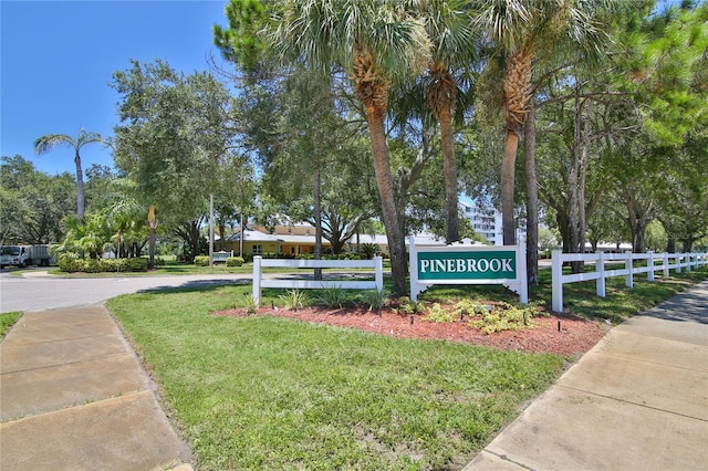 community sign featuring a yard