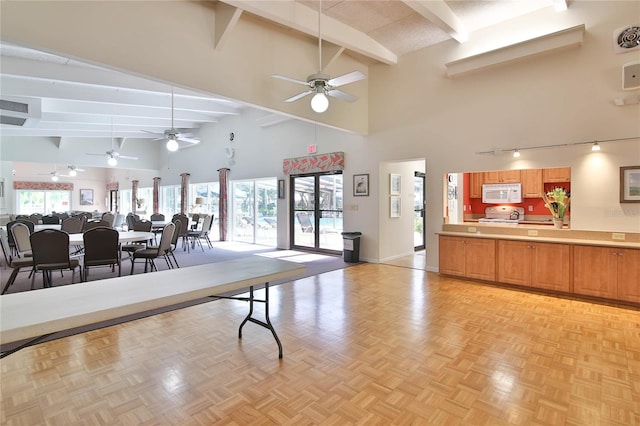 interior space featuring beam ceiling, ceiling fan, french doors, high vaulted ceiling, and light parquet flooring