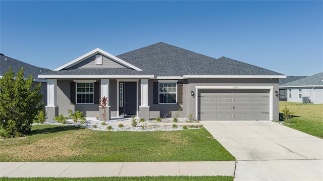 view of front of home with a garage and a front lawn