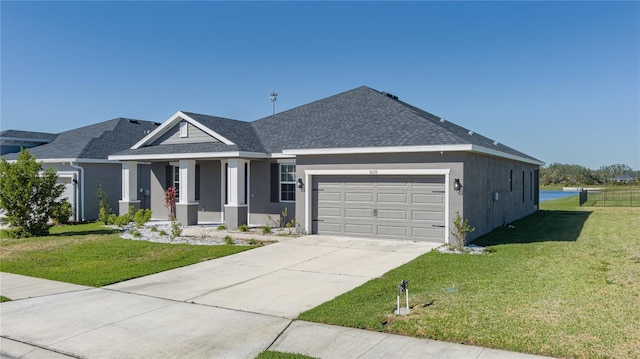 view of front of house with a garage and a front lawn