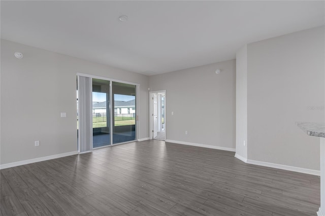 empty room with hardwood / wood-style flooring