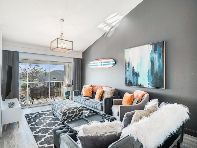 living room featuring light wood-type flooring, lofted ceiling, and an inviting chandelier