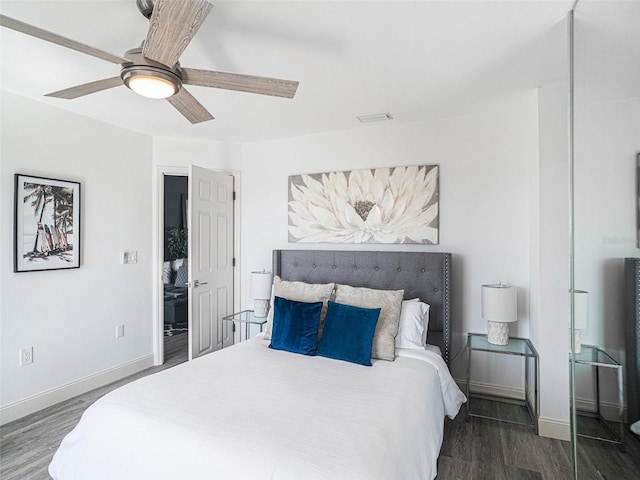 bedroom with ceiling fan and dark wood-type flooring