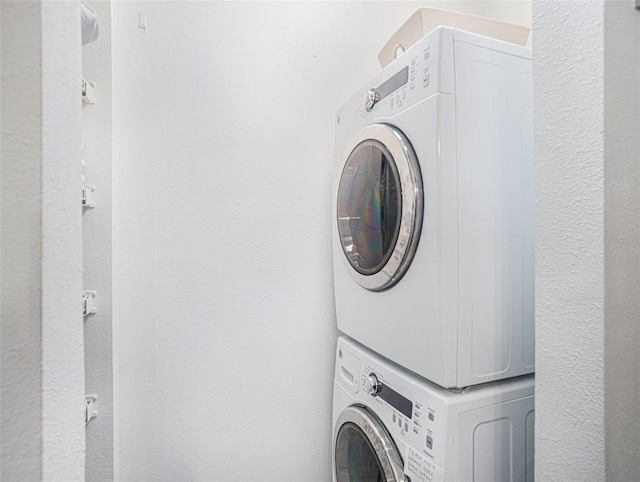 laundry area with stacked washer / dryer