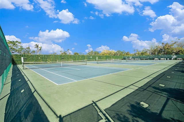 view of tennis court with basketball hoop