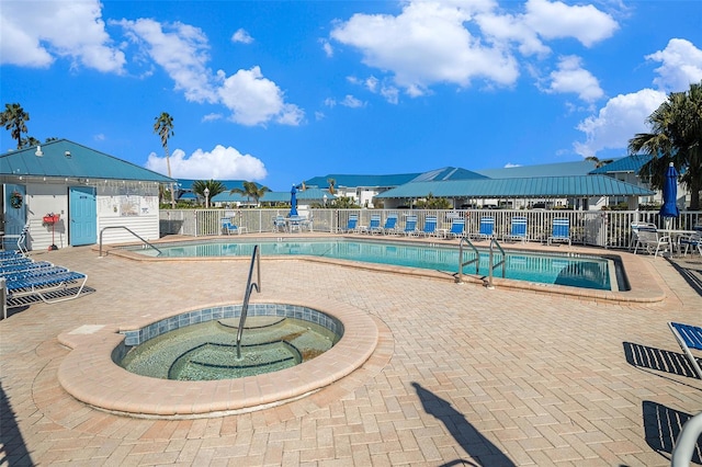 view of swimming pool featuring a community hot tub and a patio