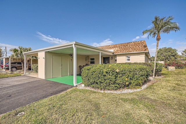 665 Park Cir Unit 58, Bradenton, FL 34207 - view of front of property featuring a front lawn and a shingled roof