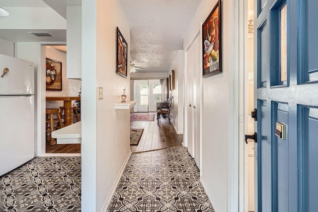 665 Park Cir Unit 58, Bradenton, FL 34207 - corridor featuring tile patterned flooring and a textured ceiling