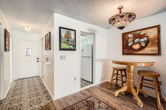 665 Park Cir Unit 58, Bradenton, FL 34207 - foyer featuring a textured ceiling and wood finished floors