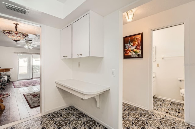 665 Park Cir Unit 58, Bradenton, FL 34207 - kitchen with white cabinetry, ceiling fan, light countertops, and tile patterned floors