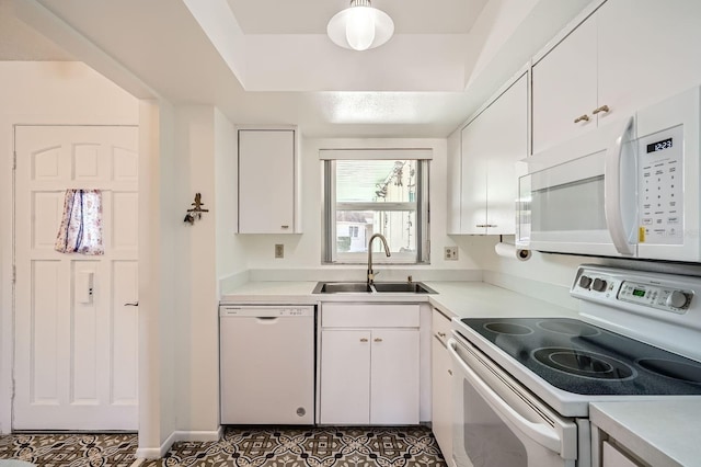 665 Park Cir Unit 58, Bradenton, FL 34207 - kitchen featuring white appliances, white cabinets, light countertops, and tile patterned flooring