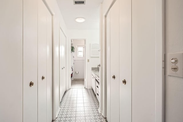 hallway with light tile patterned floors