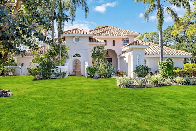 mediterranean / spanish-style home with a front yard