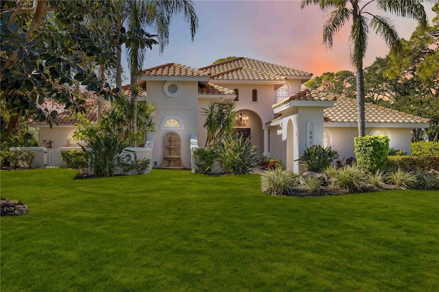 mediterranean / spanish-style house featuring a yard