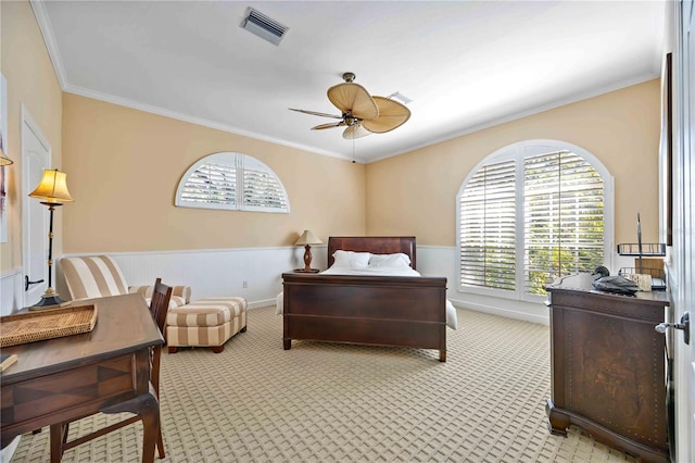 bedroom featuring ceiling fan, light carpet, and ornamental molding