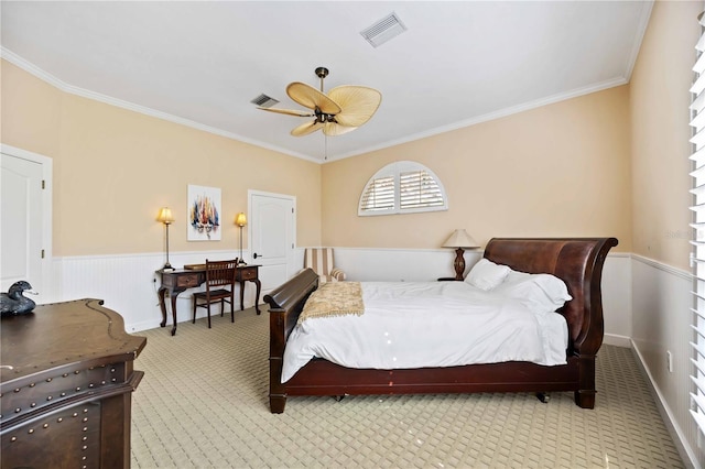 bedroom featuring ceiling fan, light colored carpet, and ornamental molding