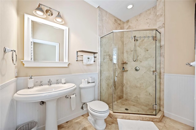 bathroom with toilet, tile patterned flooring, and walk in shower