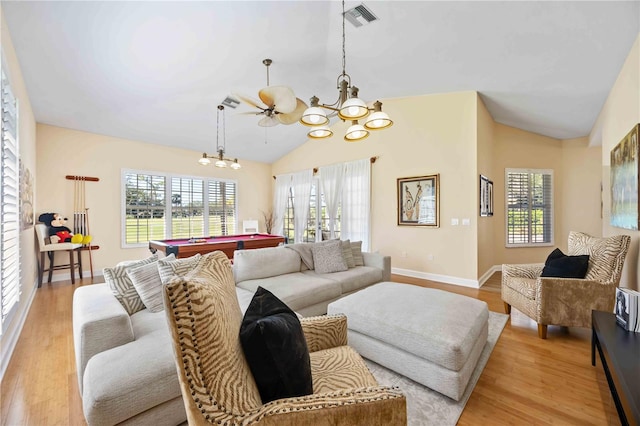 living room with ceiling fan with notable chandelier, light hardwood / wood-style floors, vaulted ceiling, and billiards