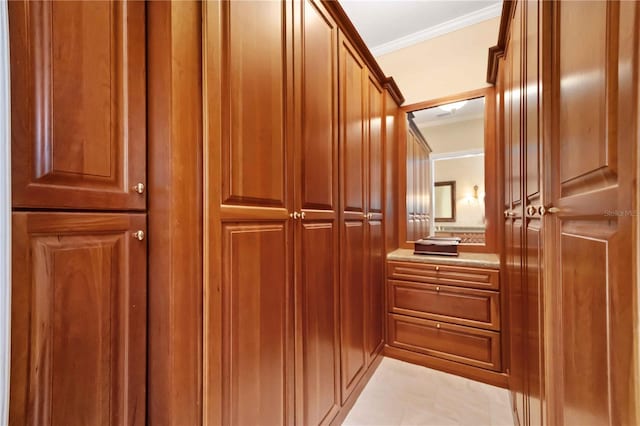 interior space with light tile patterned flooring and ornamental molding