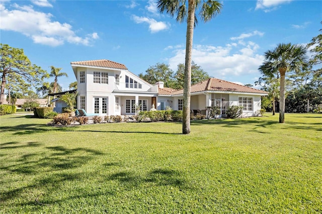 rear view of property featuring a yard