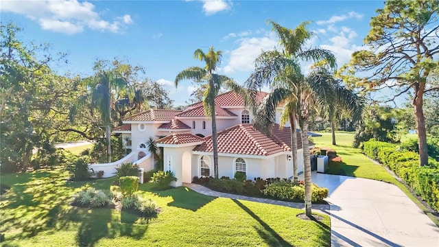 mediterranean / spanish-style house with a front lawn