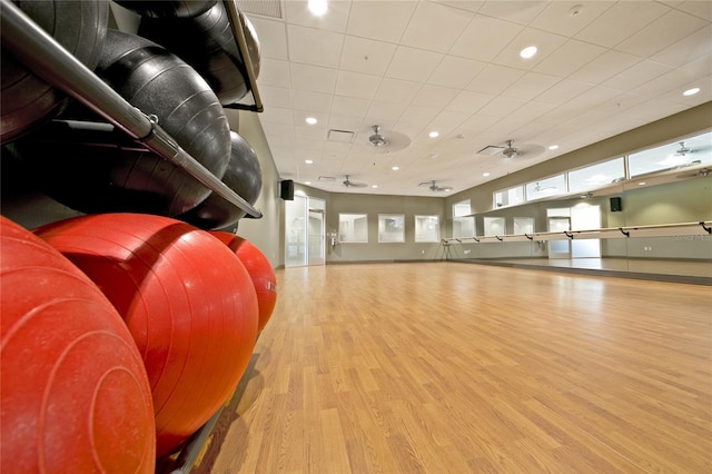 exercise room featuring light wood-type flooring and ceiling fan