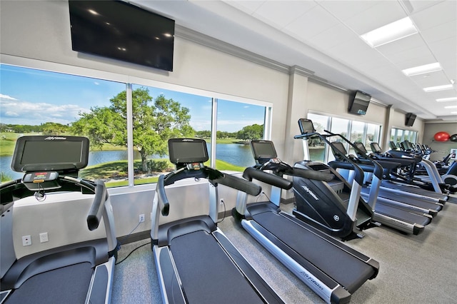 exercise room with a water view