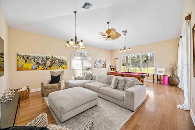 living room featuring lofted ceiling, pool table, a notable chandelier, and light wood-type flooring