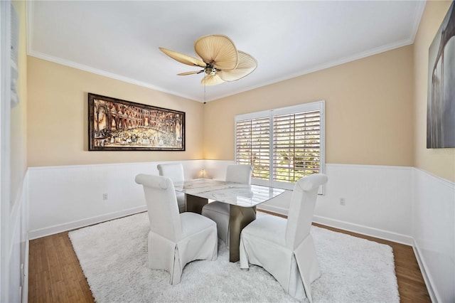 dining space with ornamental molding, dark hardwood / wood-style floors, and ceiling fan