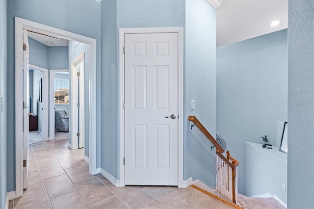 corridor featuring light tile patterned flooring