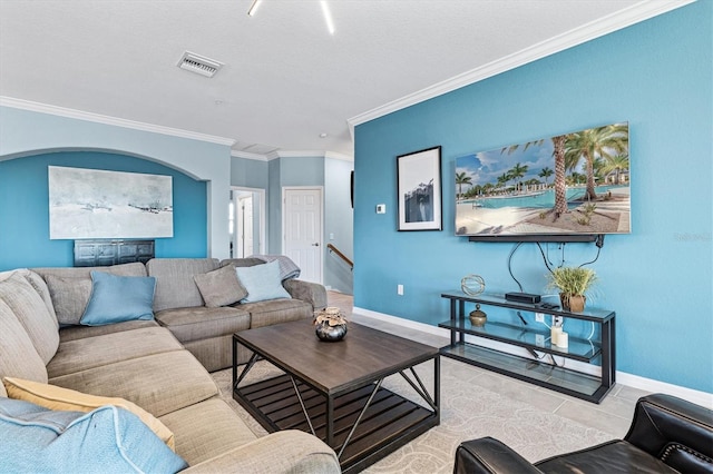 living room featuring light tile patterned floors and crown molding