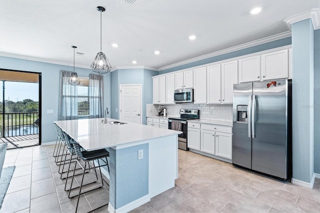 kitchen featuring white cabinetry, sink, an island with sink, and appliances with stainless steel finishes