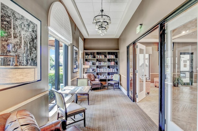 hall featuring a chandelier and parquet flooring