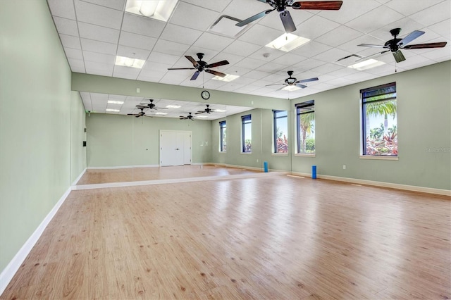 unfurnished room featuring a drop ceiling and light hardwood / wood-style flooring