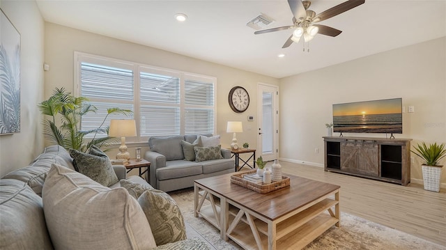 living room with ceiling fan and light wood-type flooring