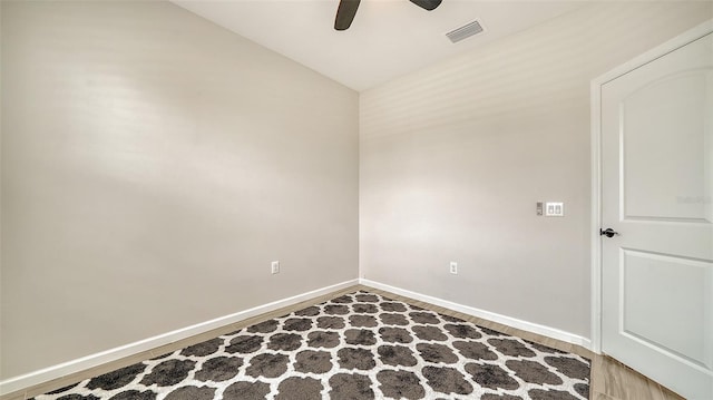 empty room featuring ceiling fan, hardwood / wood-style floors, and lofted ceiling