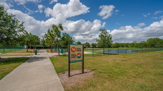 view of property's community featuring a lawn and a water view