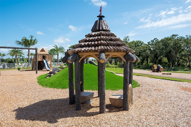 view of home's community with a playground and a yard