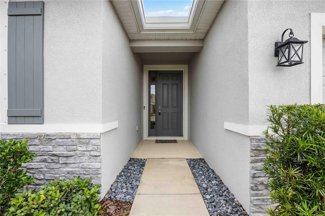 12689 Promenade Estates Blvd, Sarasota, FL 34238 - entrance to property with stucco siding and stone siding