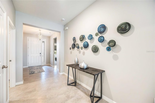 12689 Promenade Estates Blvd, Sarasota, FL 34238 - foyer featuring a chandelier and baseboards