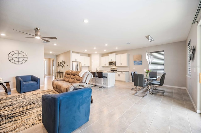 living room with light tile patterned floors and ceiling fan