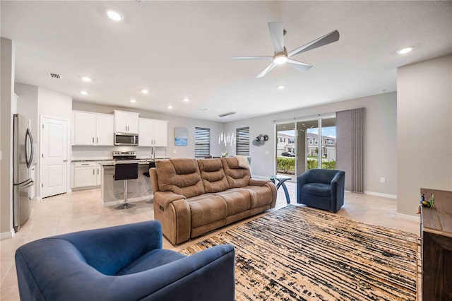 tiled living room featuring ceiling fan