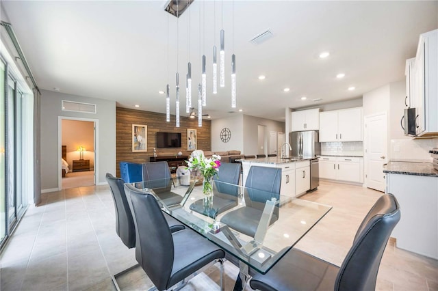 dining space with wood walls and sink